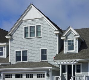 Blue-gray fiber cement shake siding on home with gray asphalt roof