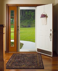 Interior of home with front door open and storm door closed